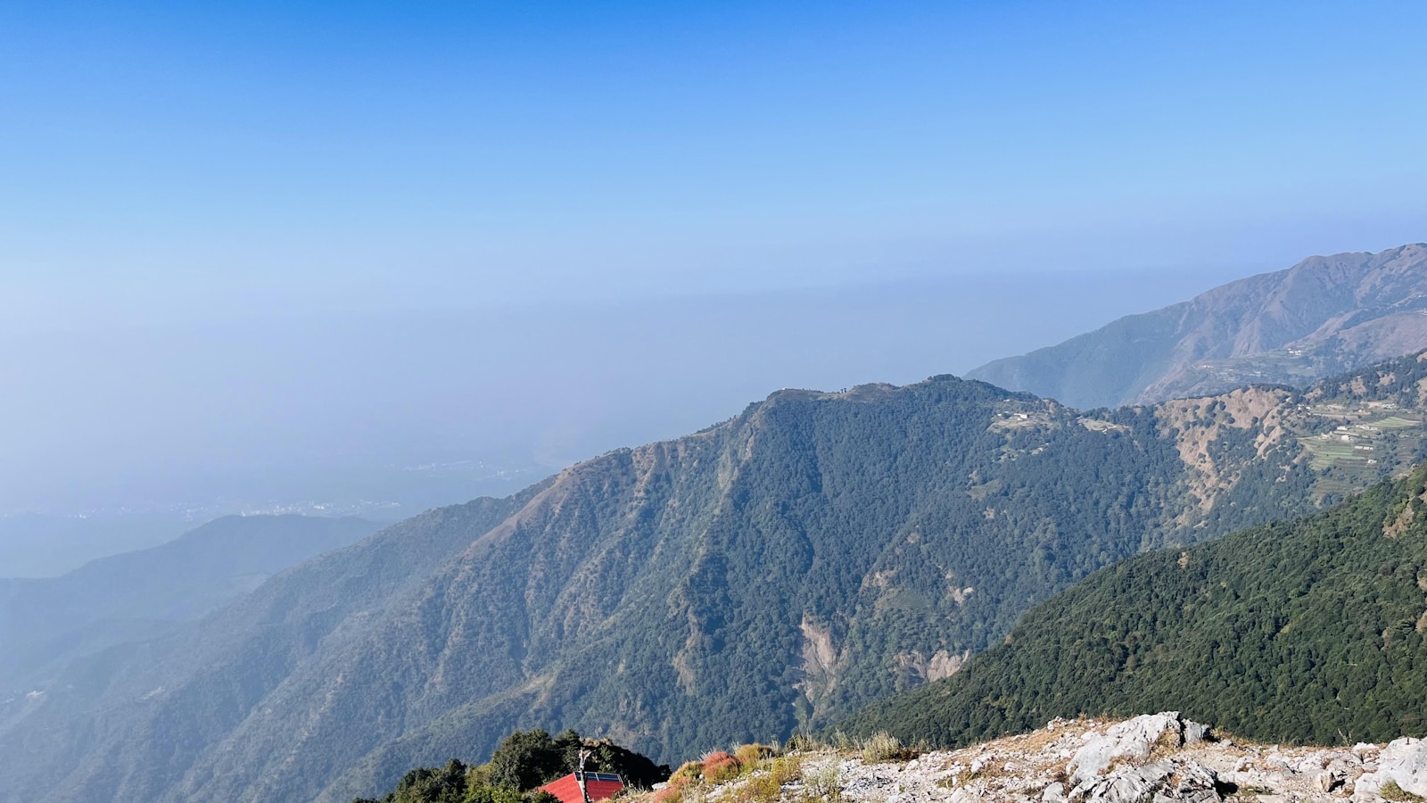 a view of a mountain range with a house in the foreground